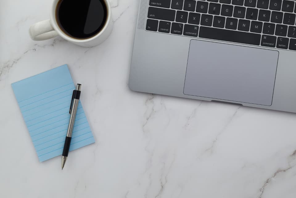 Desk flat lay with a laptop and coffee